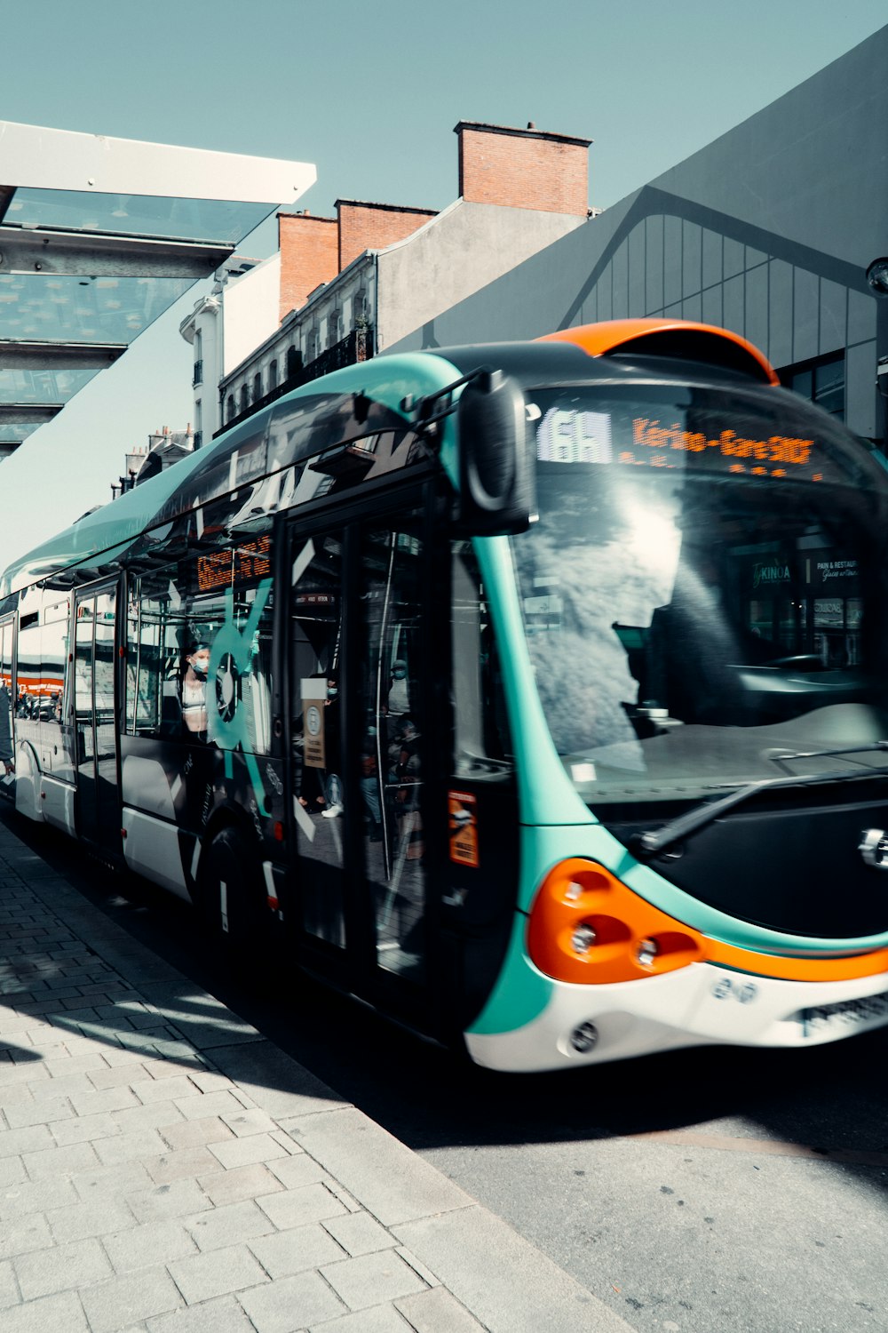 white and green bus on road during daytime