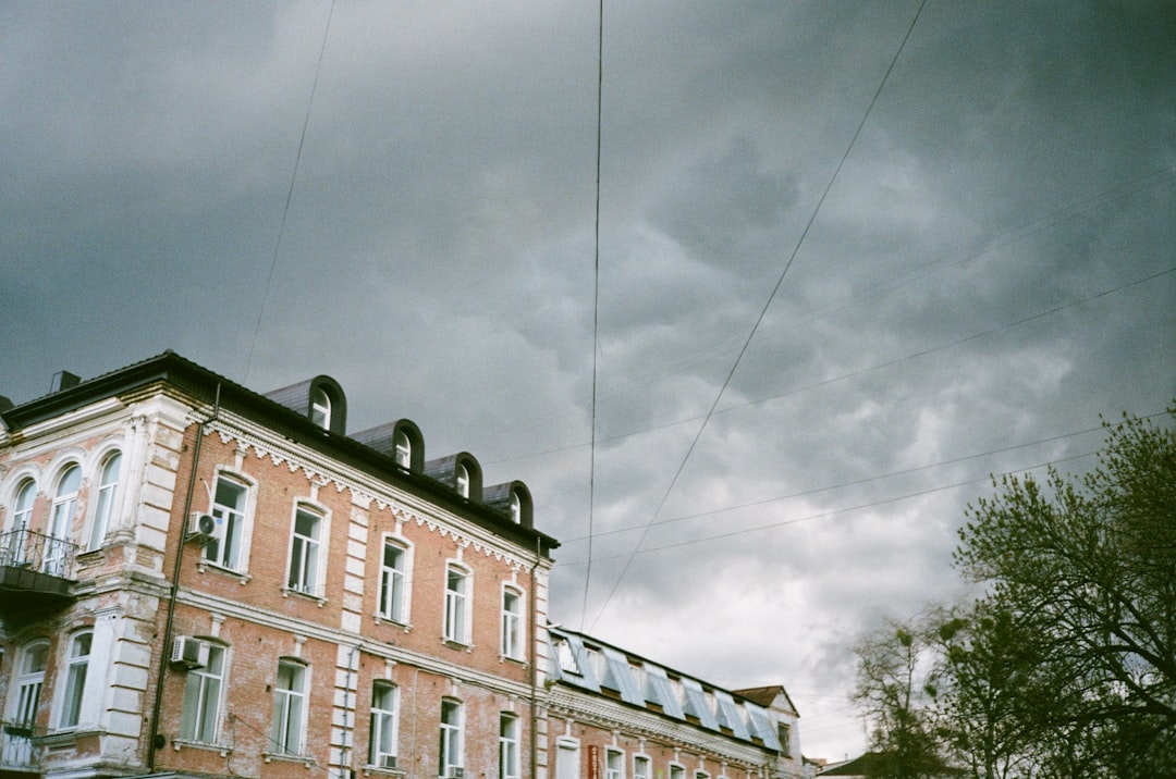 brown concrete building under gray sky