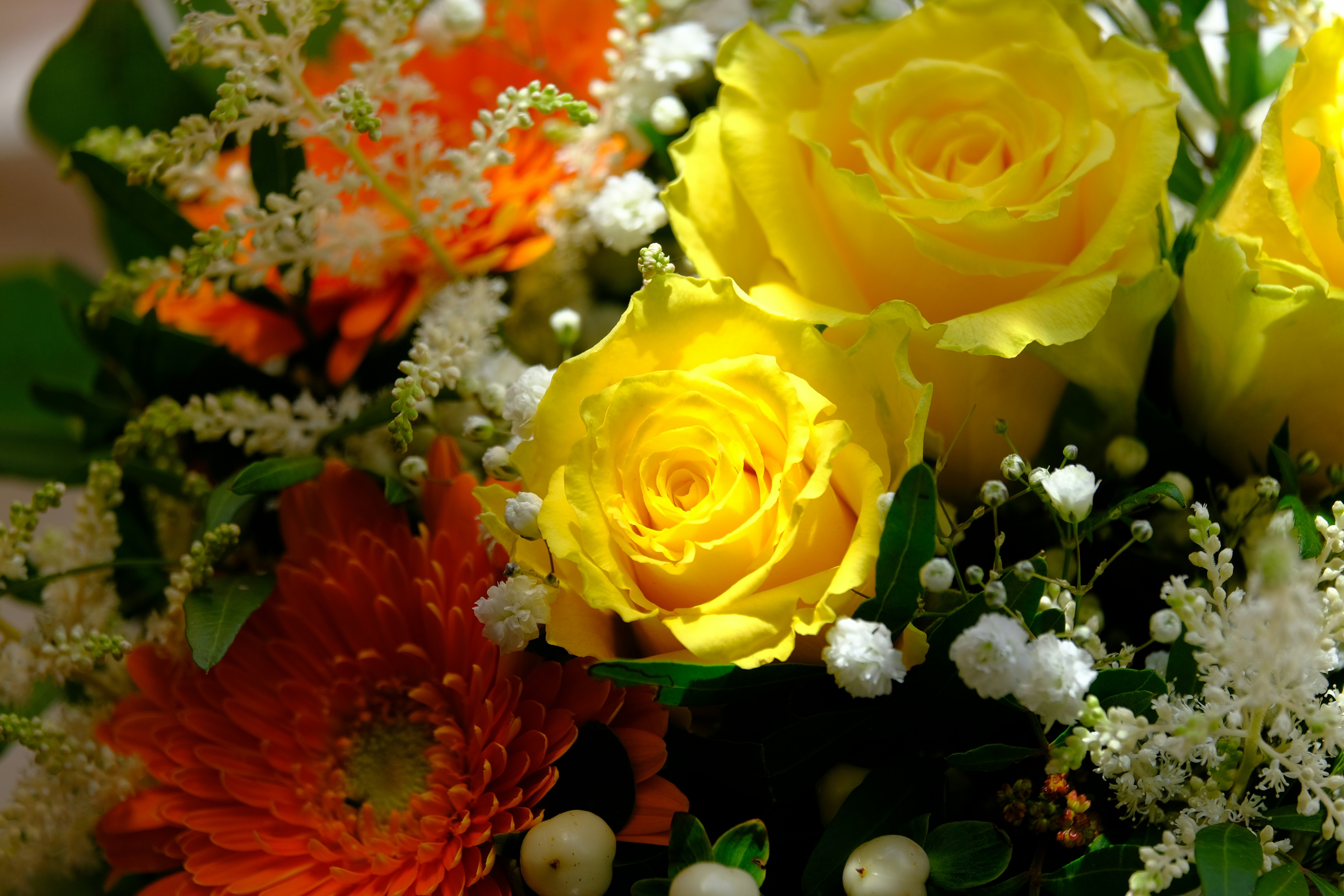 Bright golden yellow and orange flowers in a cheerful birthday bouquet arrangement