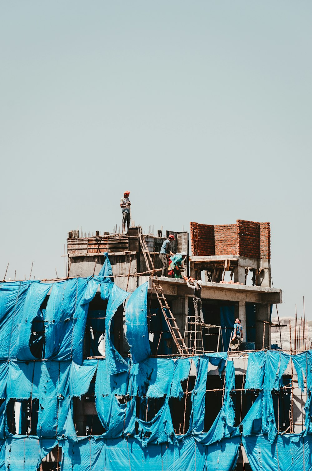 man in black shirt standing on blue and brown boat during daytime