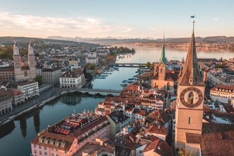 Aerial view of Zurich's old town at dawn with the River Limmat, church towers and rooftops in soft morning light