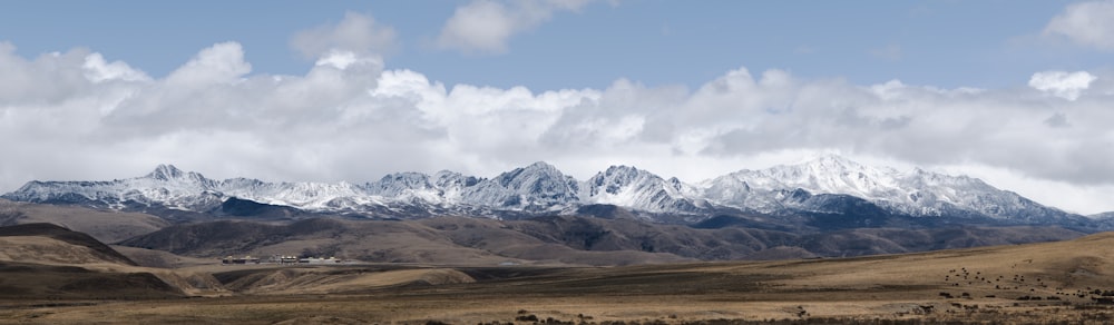 snow covered mountain under cloudy sky during daytime