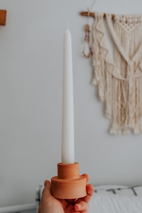 white and brown stick candle