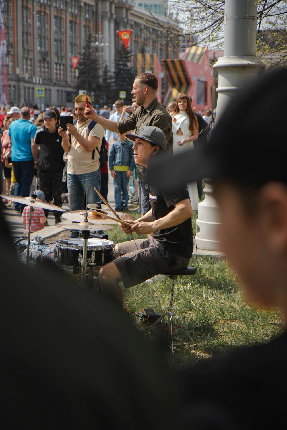 man in black t-shirt playing drum