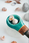 Collection of seashell charms arranged artfully on a rustic wooden surface.