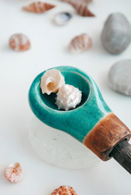 Collection of seashell charms arranged artfully on a rustic wooden surface.