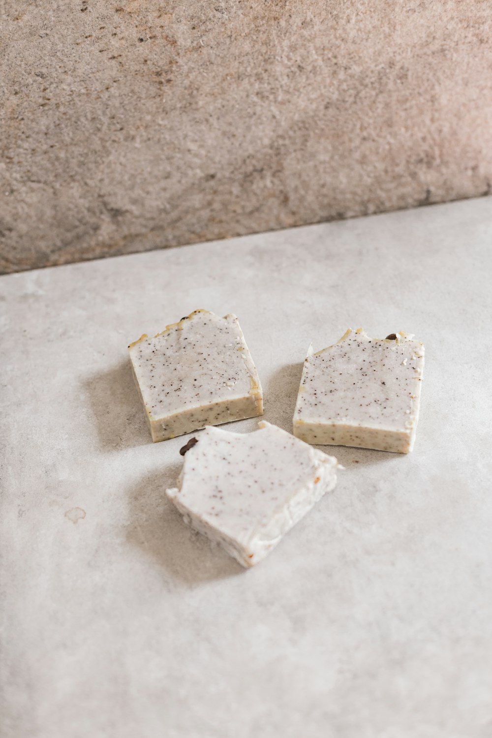 two sliced of cheese on white surface