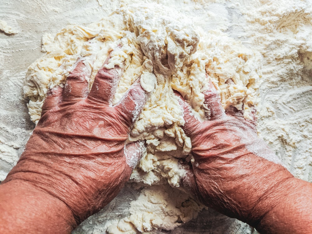 persons hand on white textile