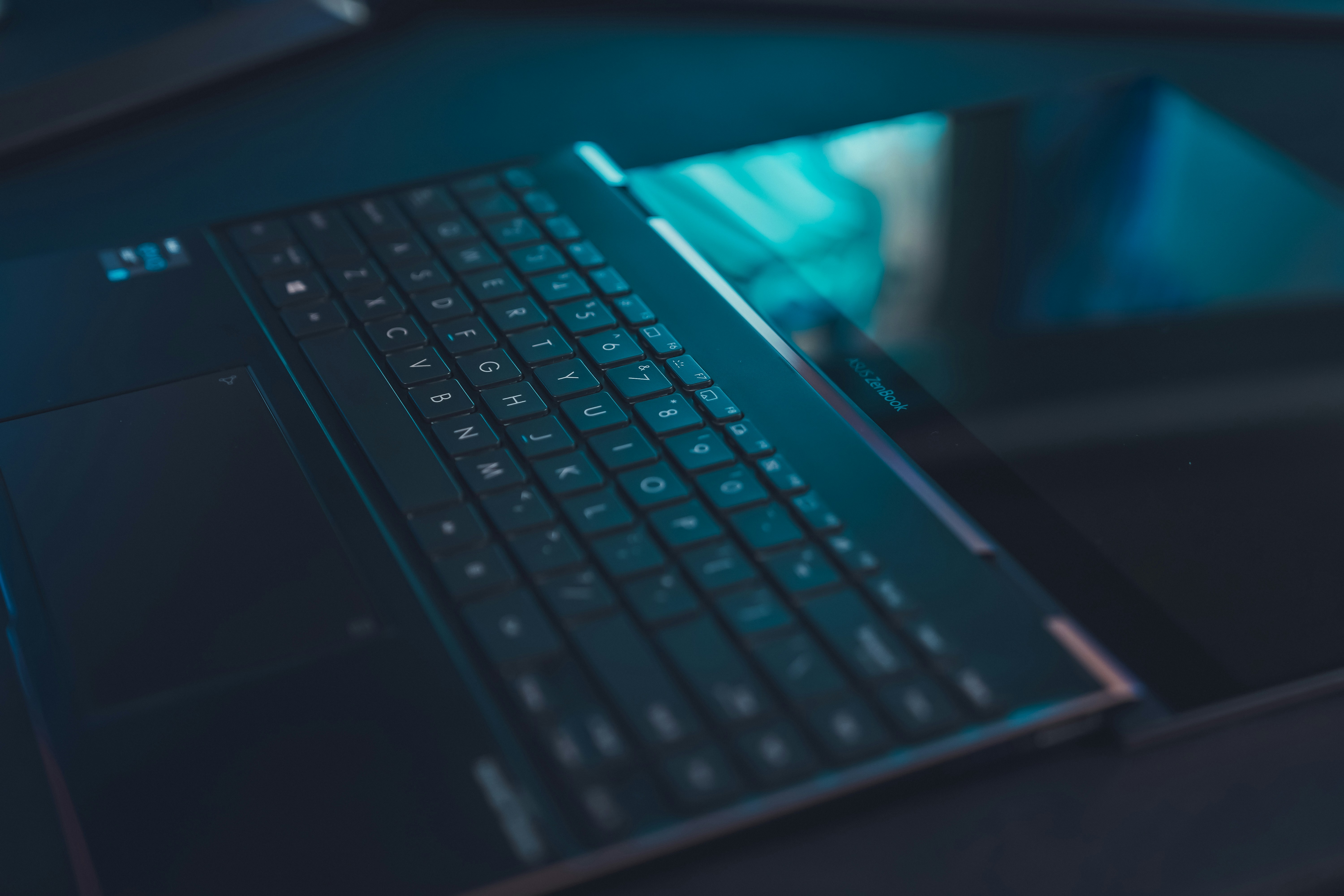 Asus laptop on black table at night