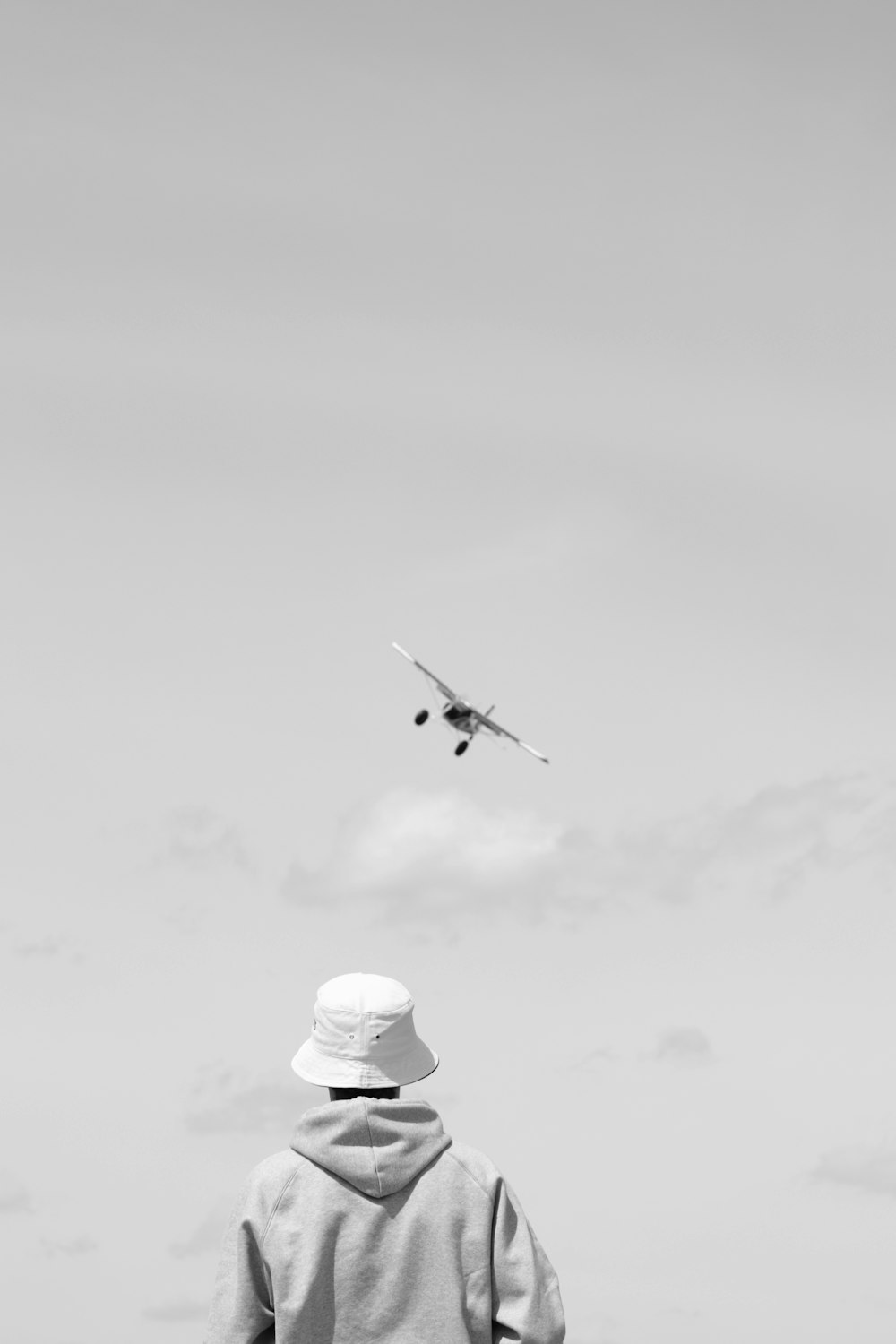 airplane in mid air under cloudy sky during daytime