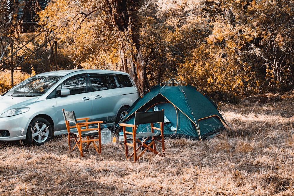 blue dome tent near brown wooden chair