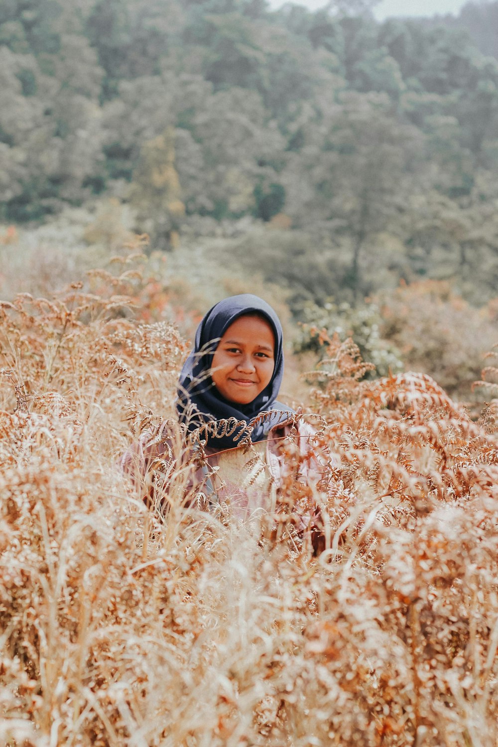 woman in black hijab on brown grass field during daytime