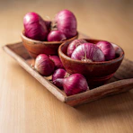 red onion on brown wooden tray