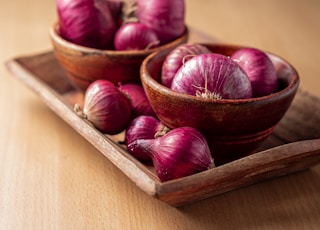 red onion on brown wooden tray