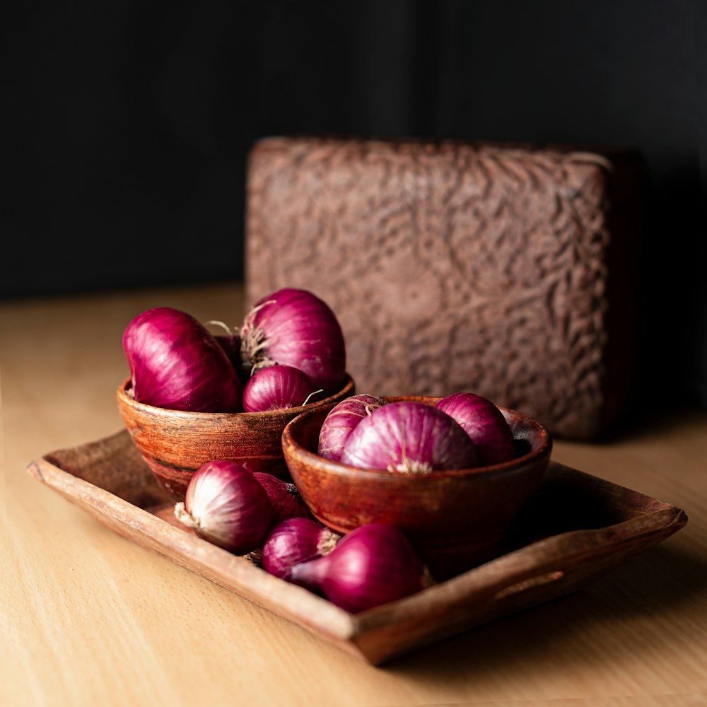 red round fruit on brown wooden chopping board