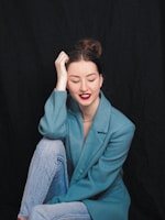 A professional woman seated at her desk, eyes closed, practicing a 15-minute meditation during lunch break.