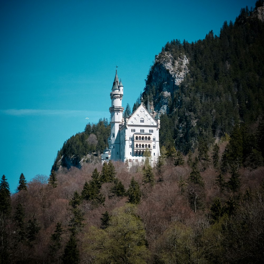 white concrete building on top of hill