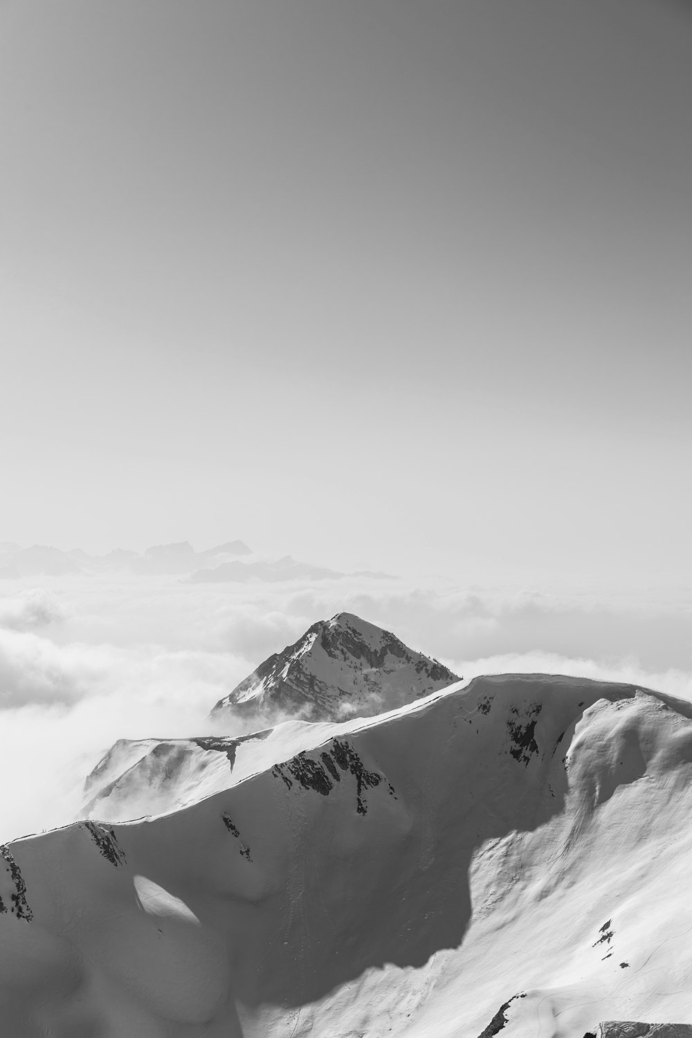 snow covered mountain under cloudy sky during daytime