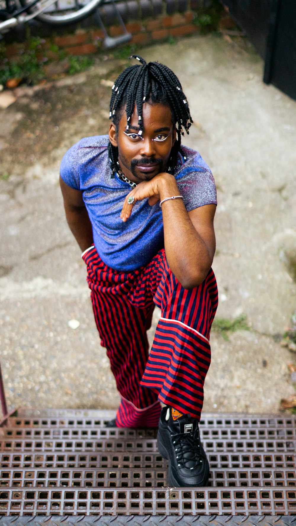 woman in blue shirt and red and white striped pants