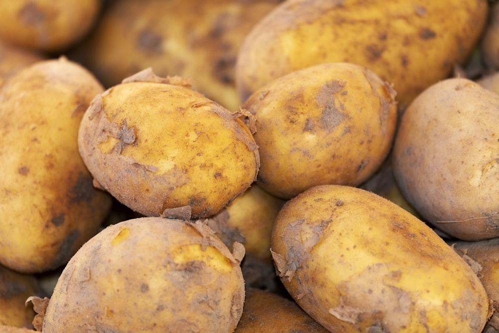 yellow potatoes on brown wooden table