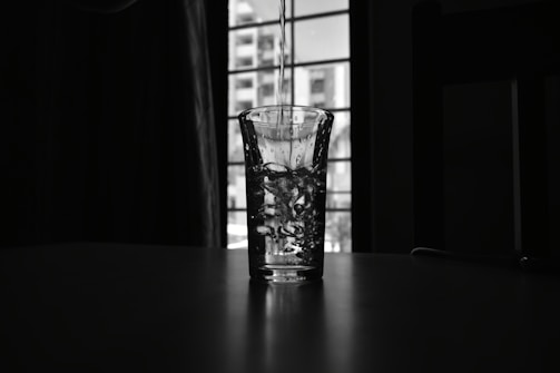 Clean water flowing from a faucet into a glass.