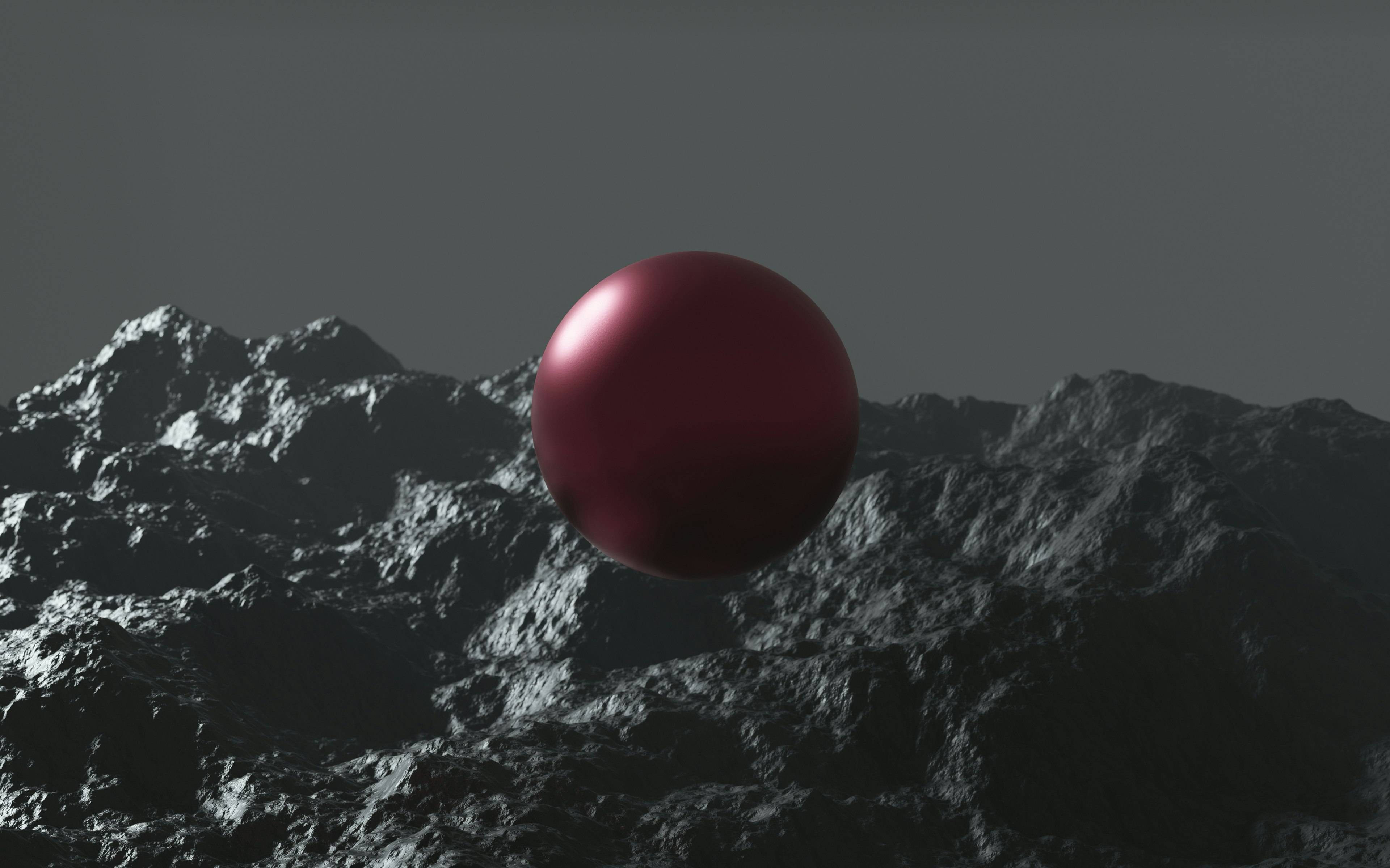 red ball on black and white mountain