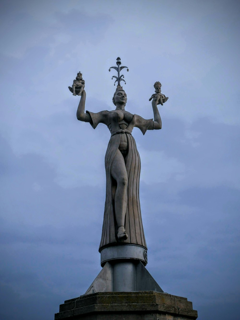 man holding a cross statue