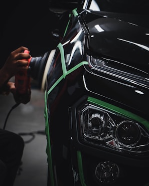 Black car getting a paint correction and polish and ceramic coeating