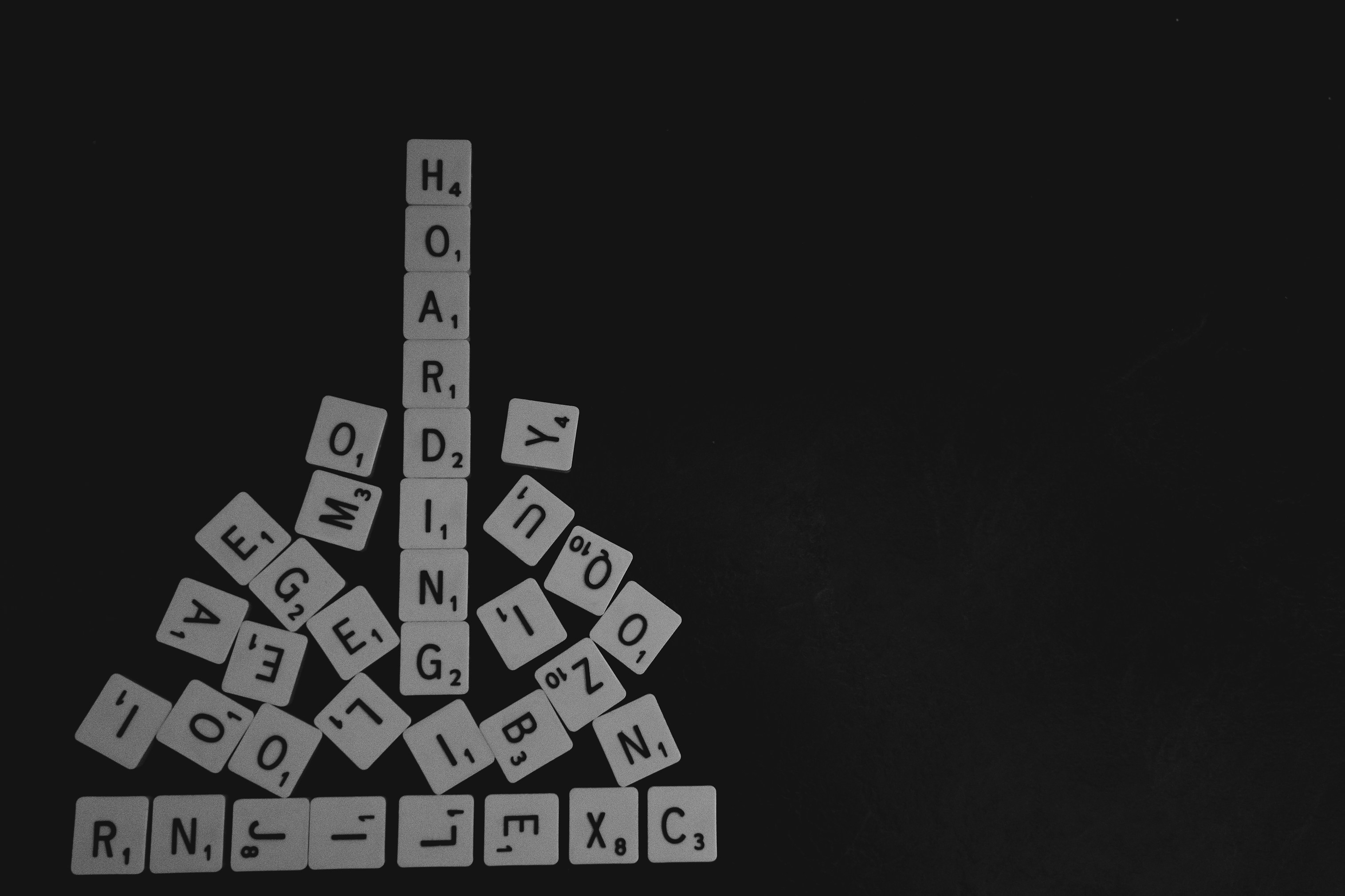 The word hoarding in scrabble letters, surrounded by other letters that have been collected.