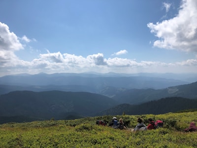 A vibrant photo of travelers enjoying a scenic mountain tour with backpacks and smiles.