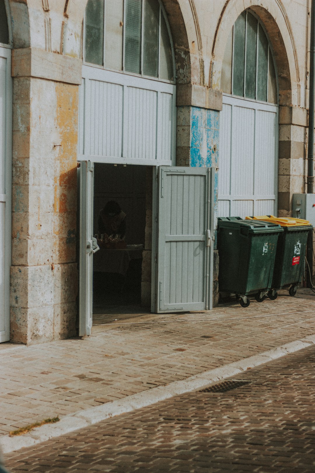 man in black jacket walking on sidewalk during daytime