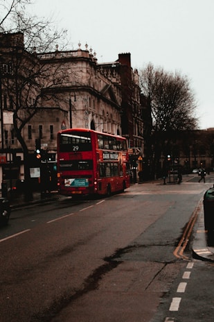 A charming street view of London with classic red double-decker buses and historic buildings.
