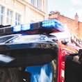 black and blue car in front of red car