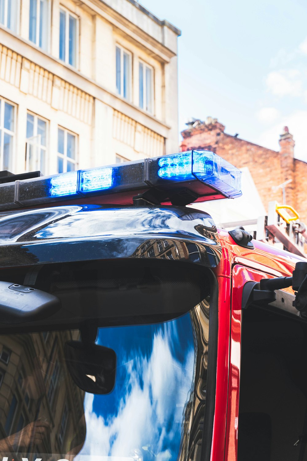 black and blue car in front of red car