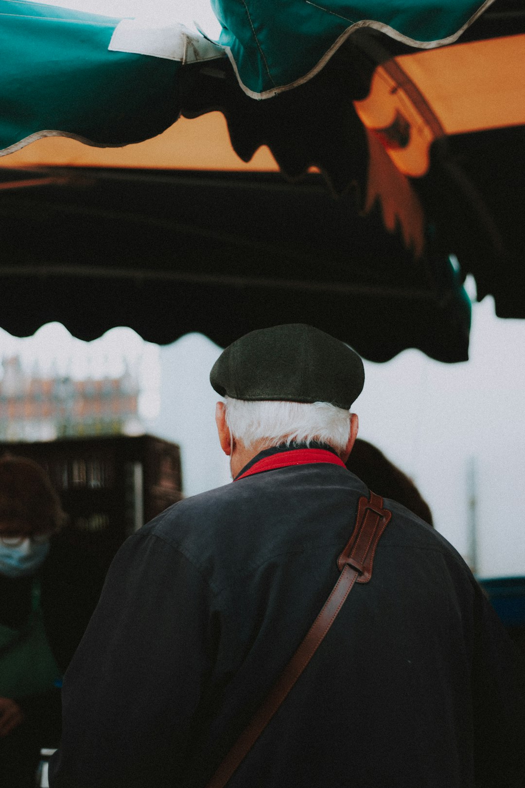 man in black jacket and white cap