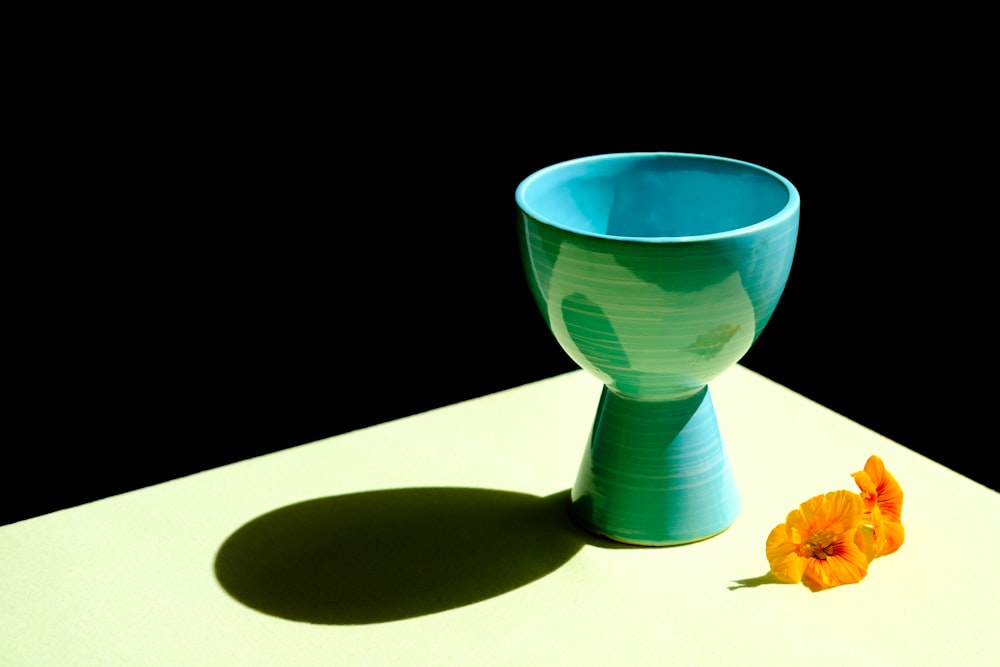 blue ceramic cup on white table