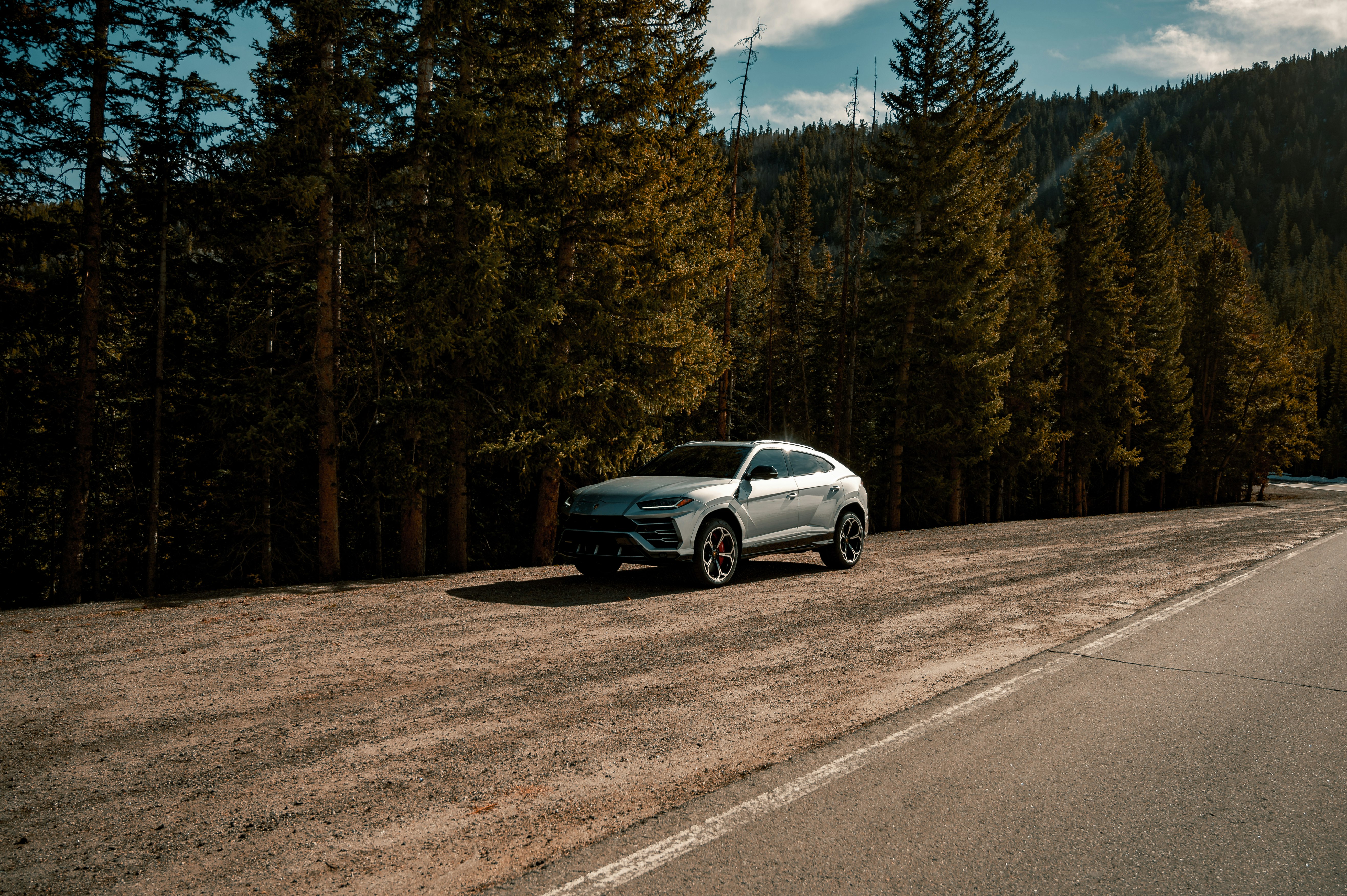 silver sedan on gray asphalt road during daytime