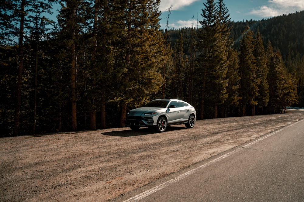 silver sedan on gray asphalt road during daytime