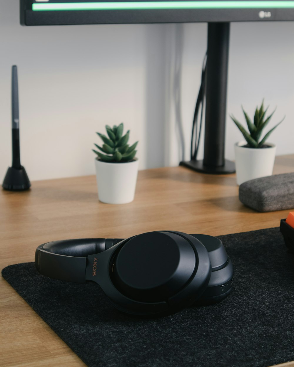 black sony headphones on brown wooden table