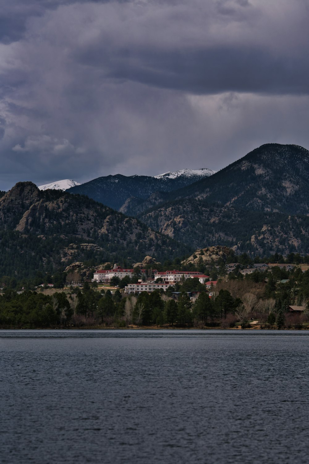 green and brown mountain near body of water during daytime