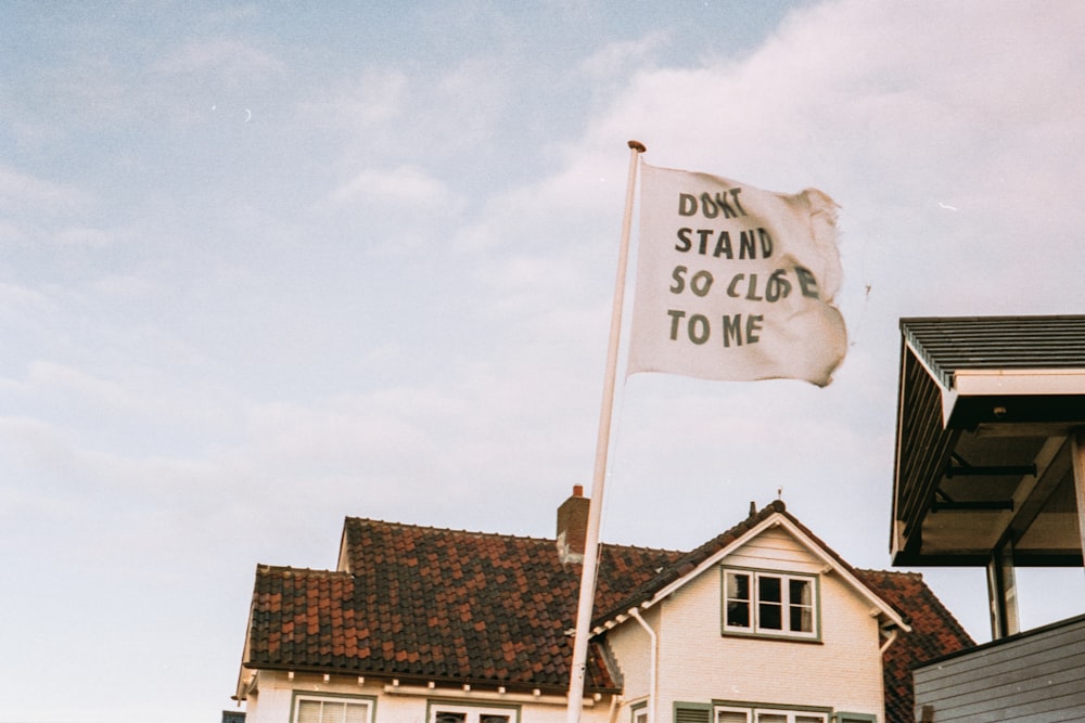 a flag flying in front of a white house