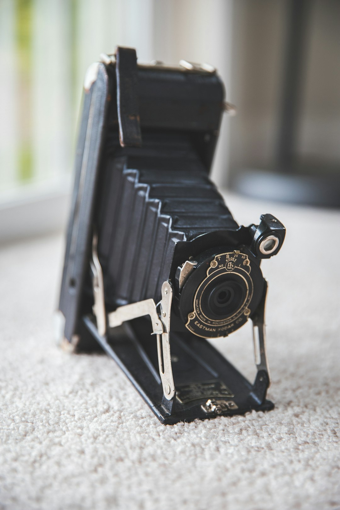 black and silver camera on gray carpet