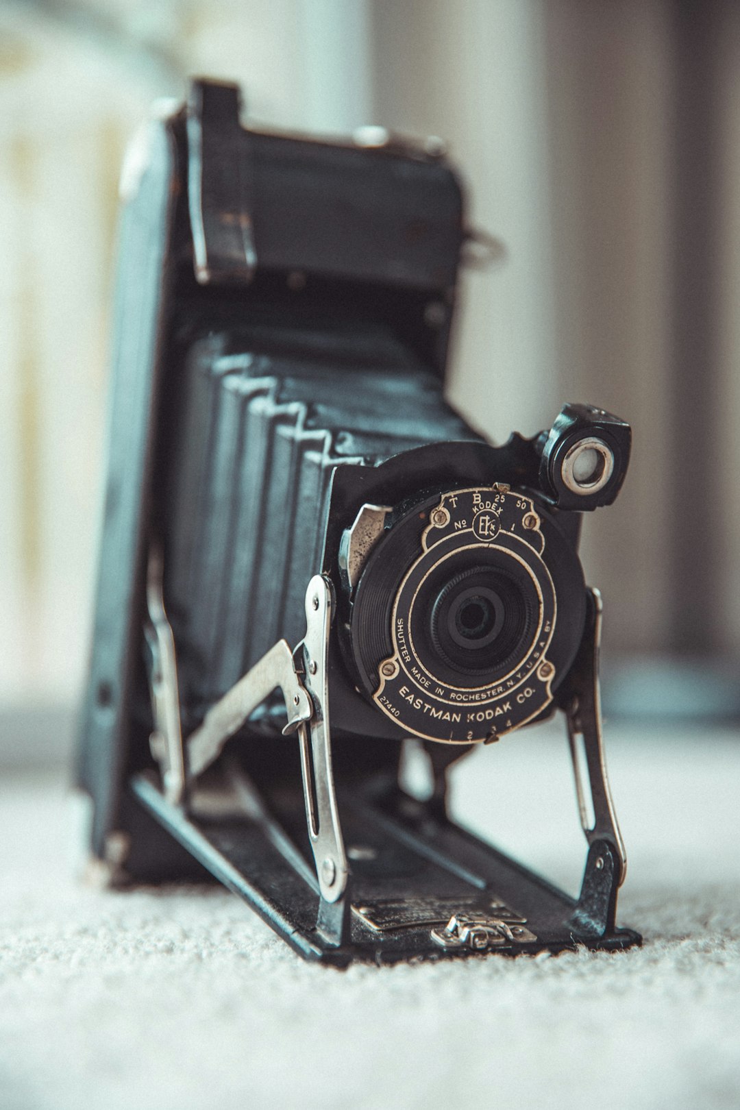 black and silver camera on brown wooden table