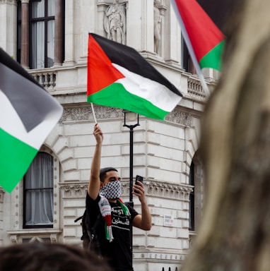 man in black t-shirt holding flag of india during daytime