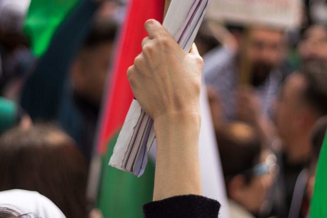 person holding silver and red folding umbrella