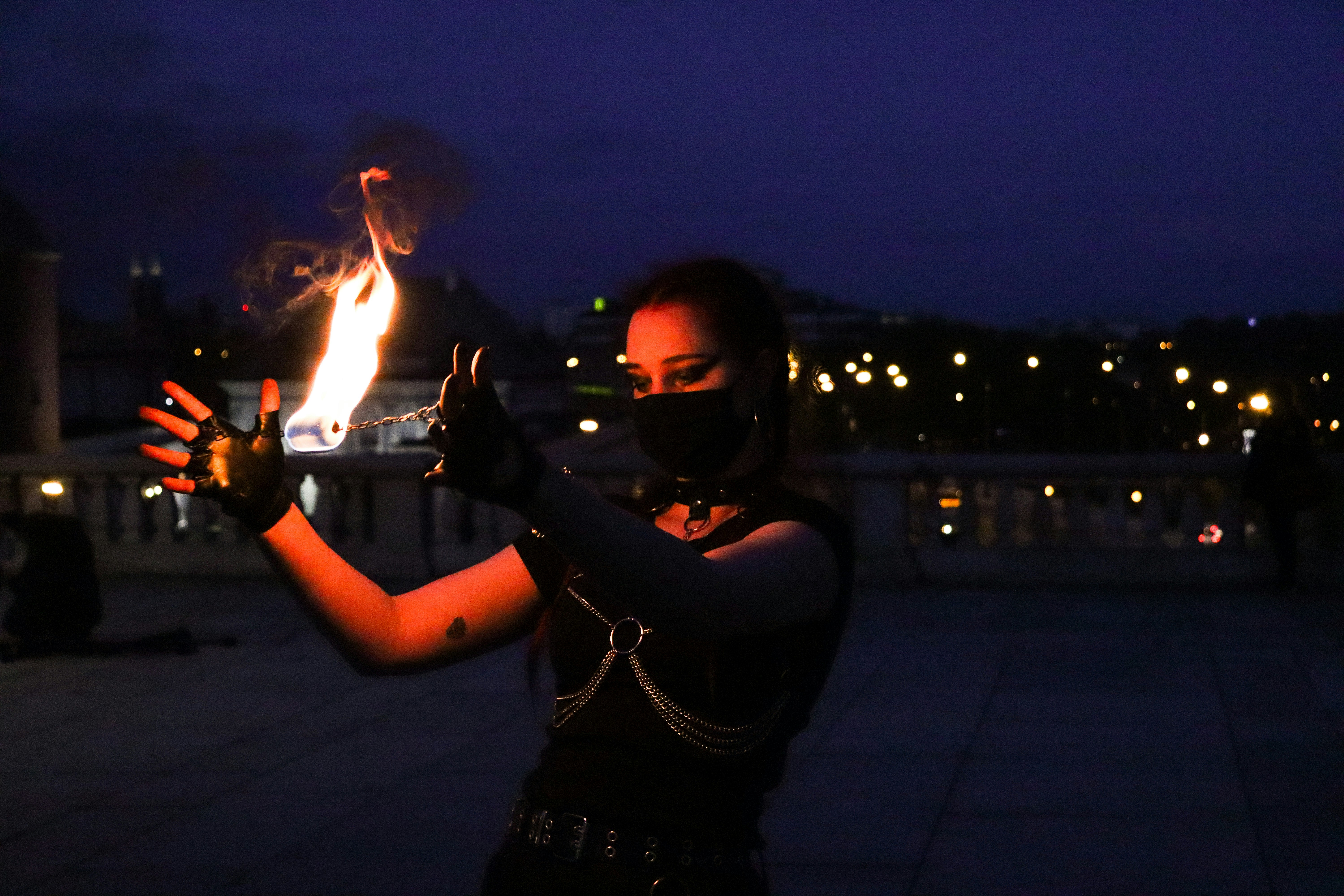 woman in black long sleeve shirt holding fire during night time