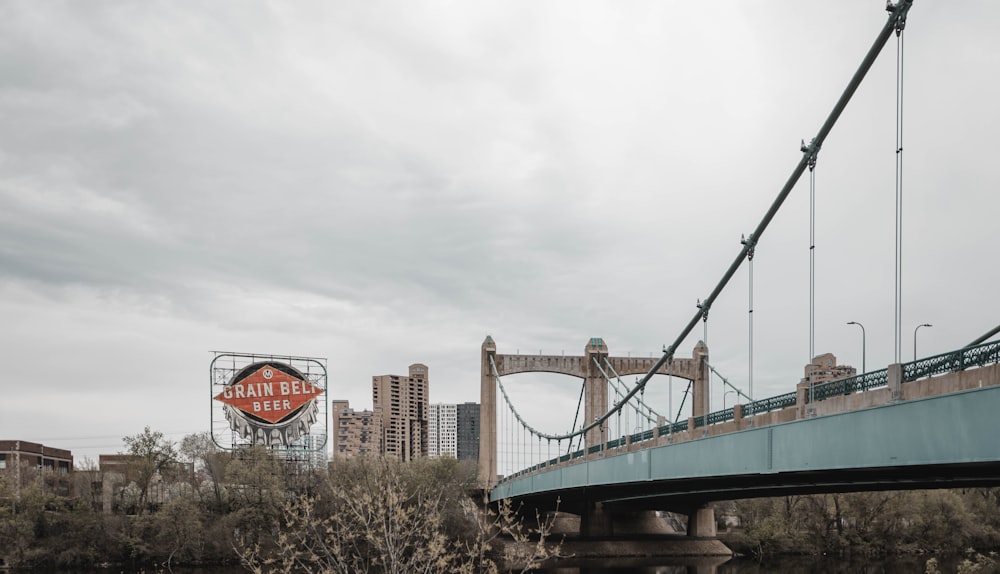 green bridge under white clouds during daytime