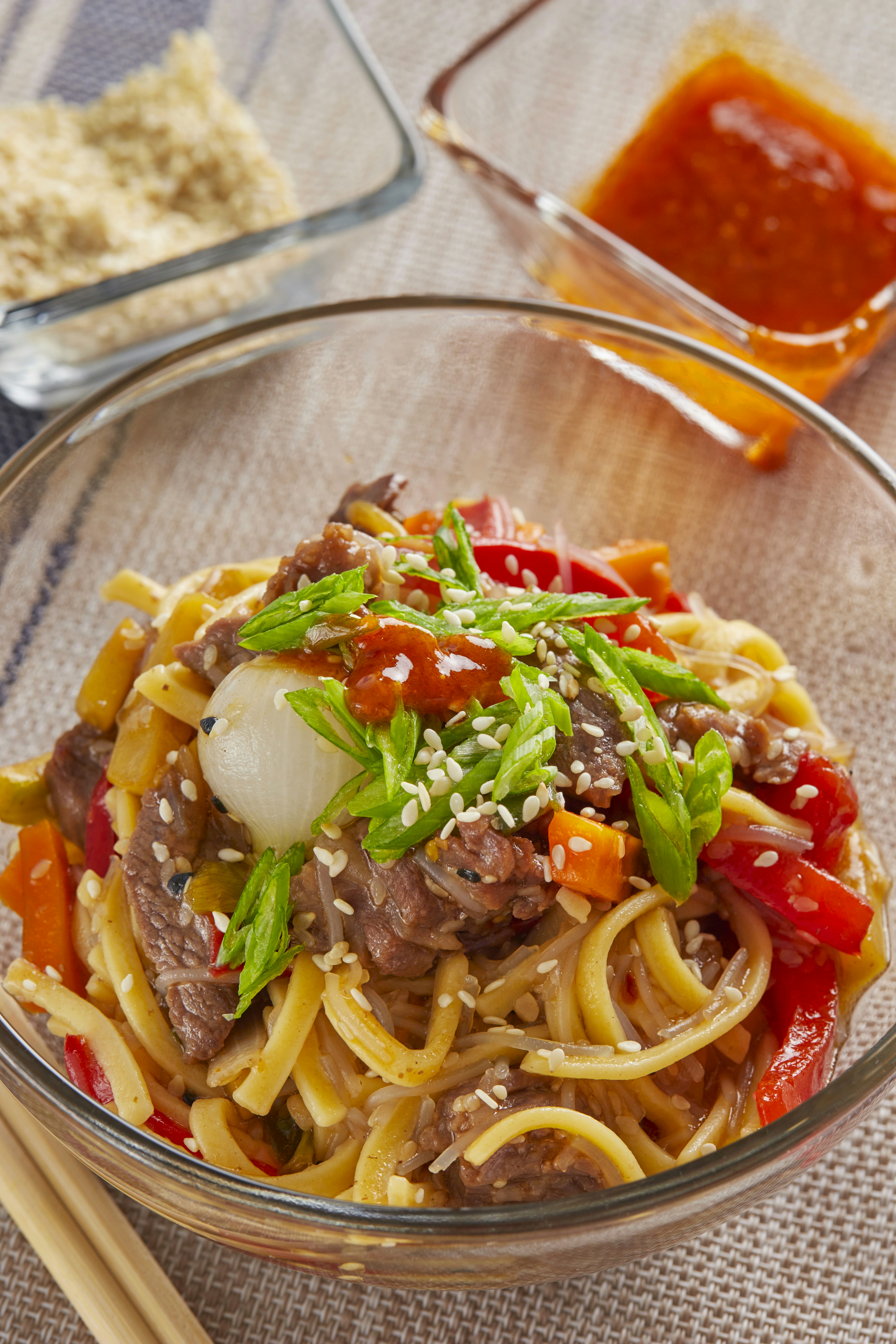 Beef stir fried noodles with tender sliced beef, vegetables and egg noodles in dark savory sauce