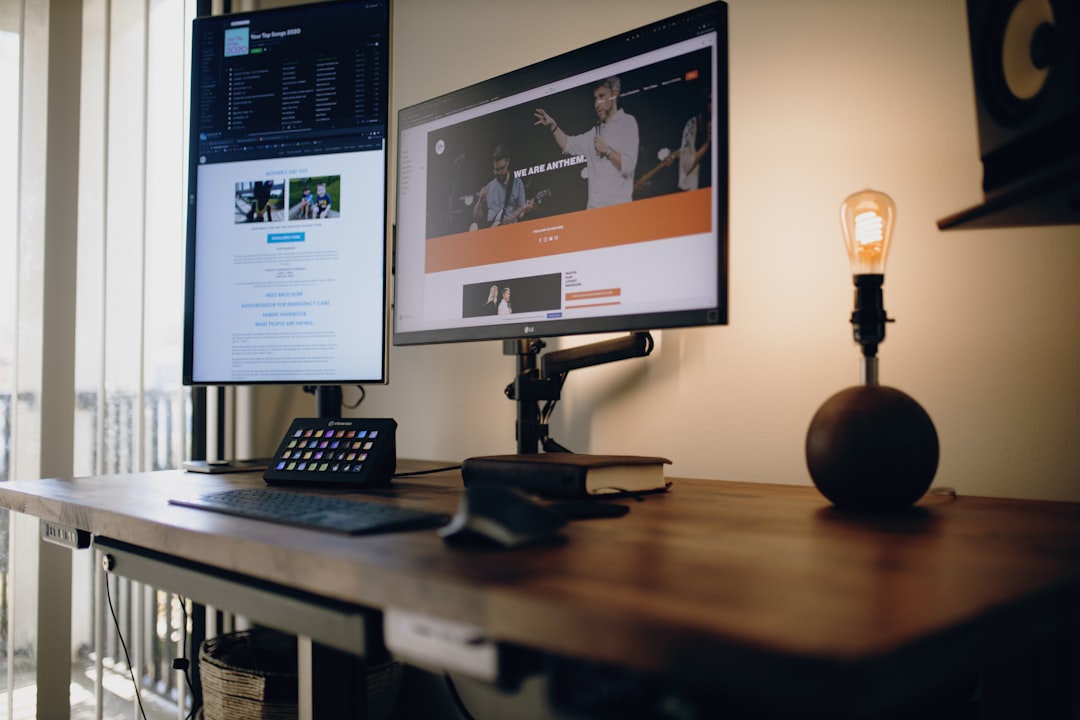 black flat screen computer monitor on brown wooden desk