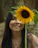 A candid shot of a person journaling with sunflower artwork nearby, symbolizing strength and acceptance.